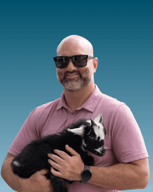 A Ripple Room member holding a baby goat